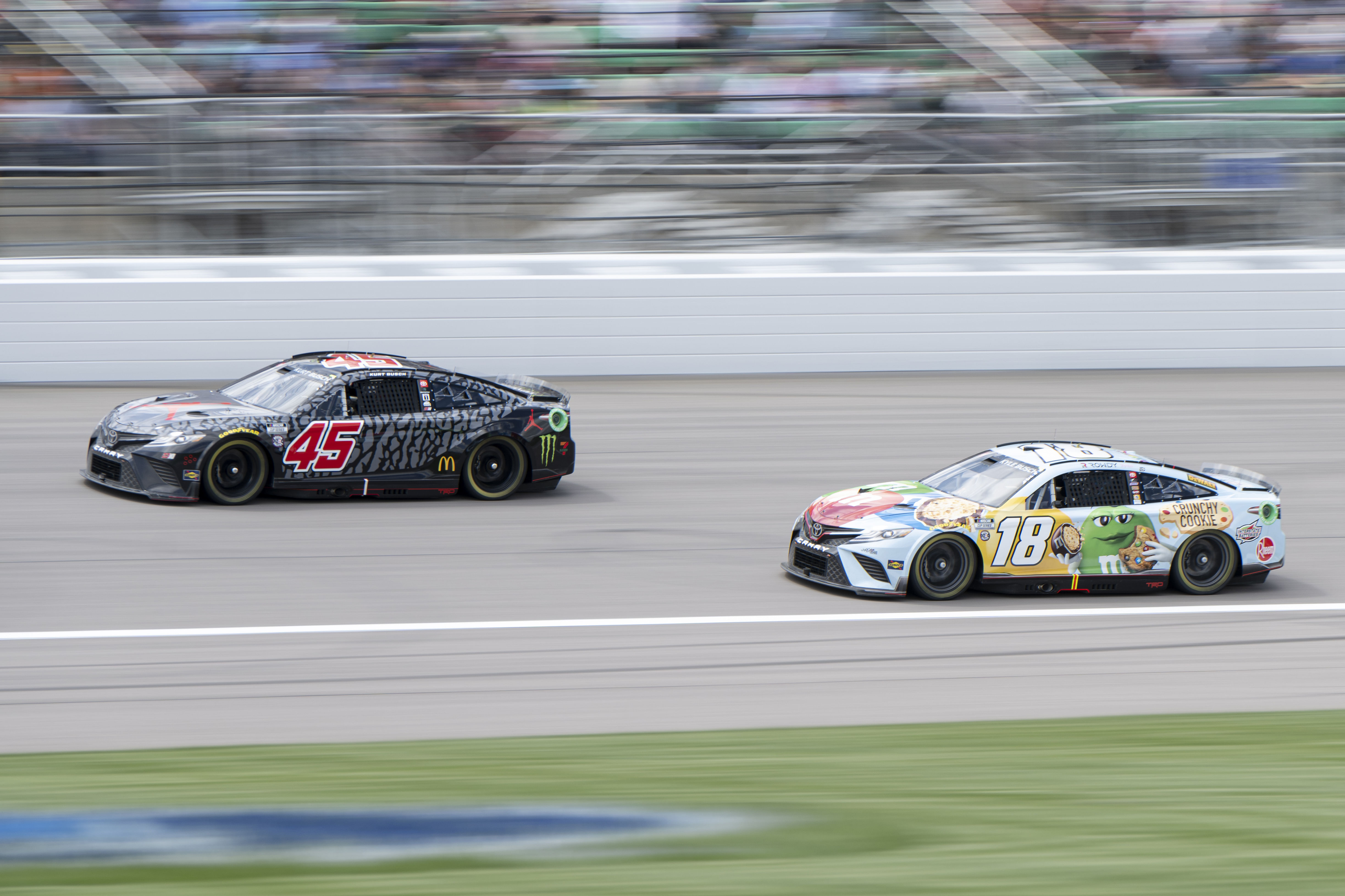 Kyle Busch (#18) and Kurt Busch (#45) at Kansas Speedway in 2022 - Source: Imagn